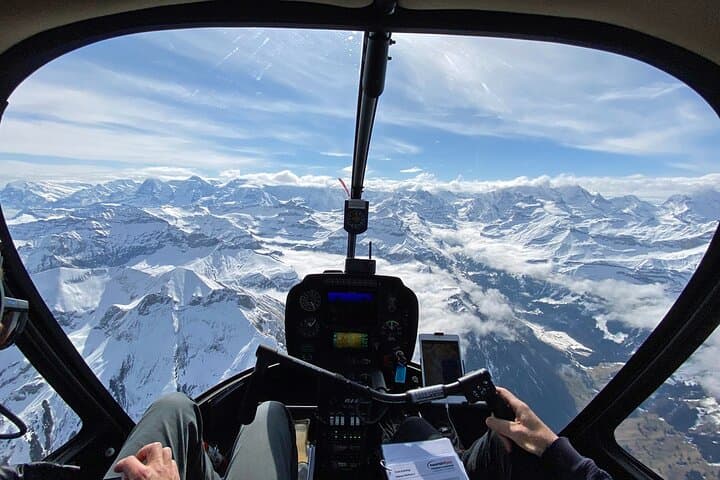 Private Swiss Alps helicopter tour over snow covered mountain peaks and glaciers